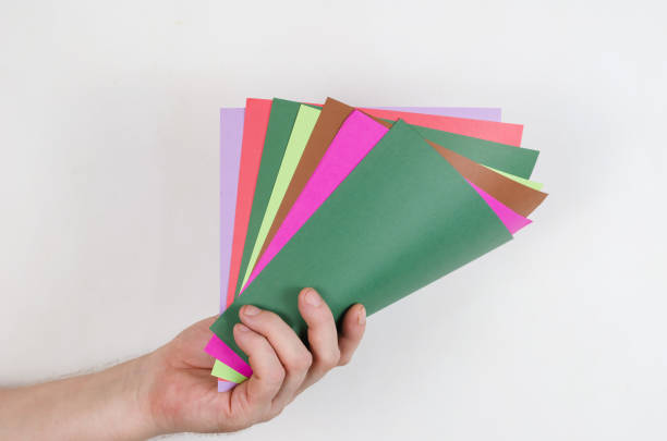 istock A man holding a colorful paper against a white background. Squar 1336051701