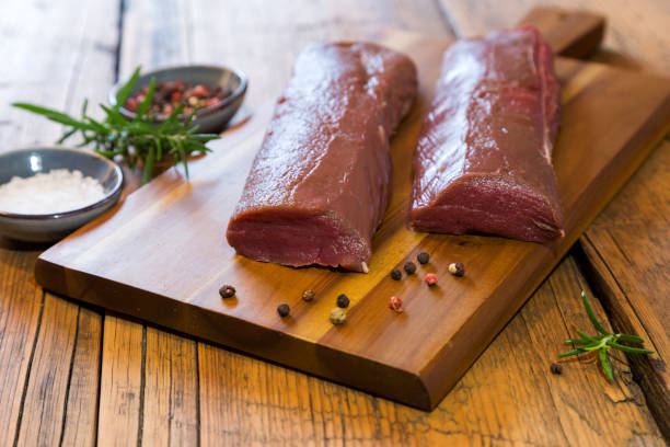 fresh venison back on wooden board fresh venison back on wooden board animal back stock pictures, royalty-free photos & images