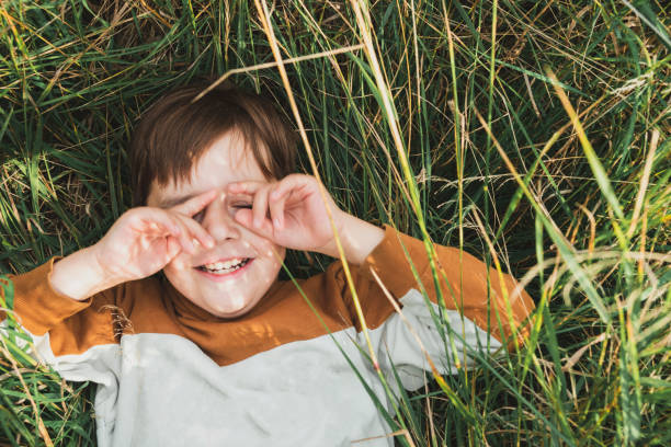 istock A cute boy is lying on the grass 1336056685