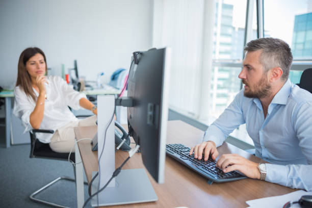 istock Businessman composing an e-mail with his colleague in the office 1336056854