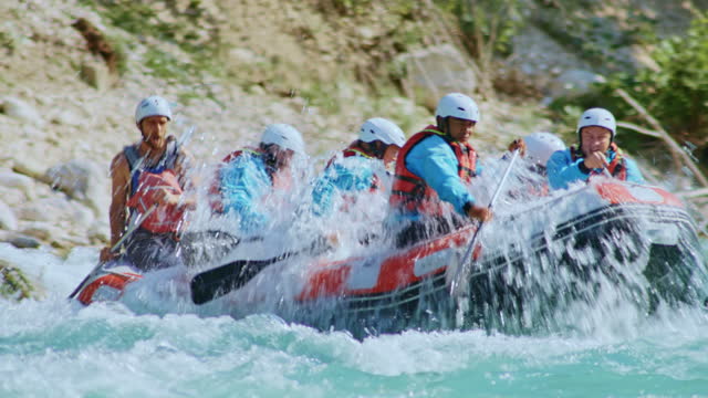 TS A group of people paddling a raft