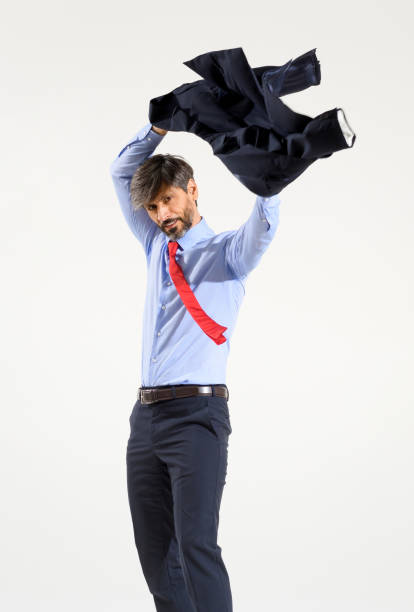 istock Stylish businessman putting on his suit jacket on white 1336056953