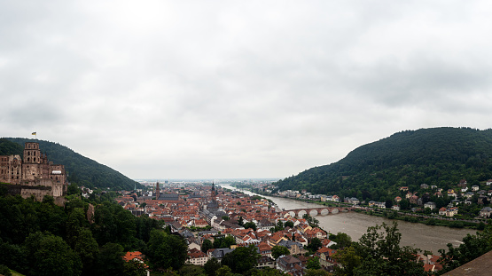 Panorama view of Heidelberg in the morning on a cloudy day with the Neckar River running through the city. Photo taken in Heidelberg, Germany