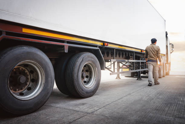 Semi Trailer Truck A Parking with Truck Driver. Industry Cargo Freight Truck Transport and Logistics. Semi Trailer Truck A Parking with Truck Driver. Industry Cargo Freight Truck Transport and Logistics. shipping heavy equipment machinery stock pictures, royalty-free photos & images