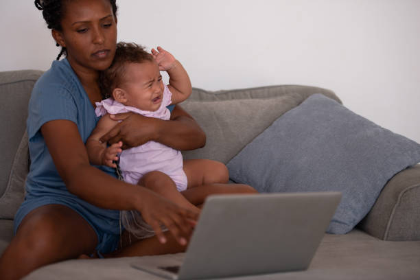 istock Mother working online while sitting with baby child. 1336059238