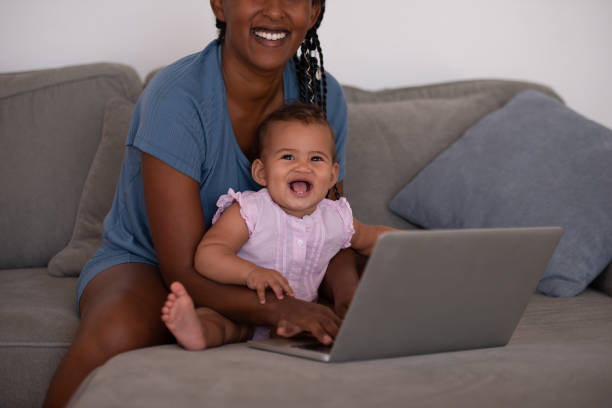 istock Mother working online while sitting with baby child. 1336059313