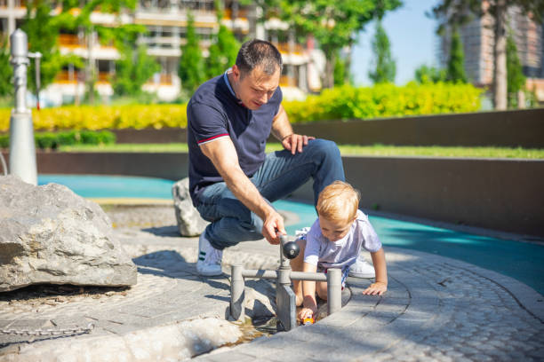 istock Father and son playing in the public park 1336059561