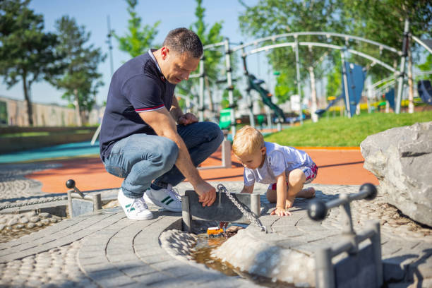 istock Father participating in his child's play in the park 1336059573