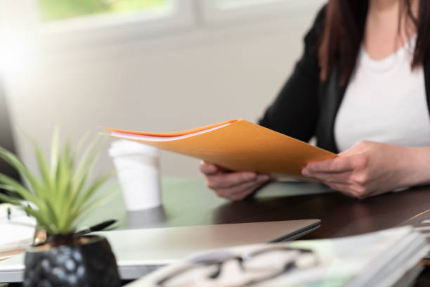 istock Businesswoman holding folder 1336061029