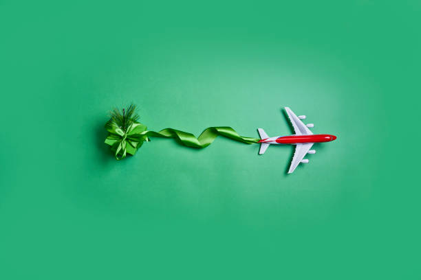 istock Christmas vacations concept with airplane and ribbon 1336061104