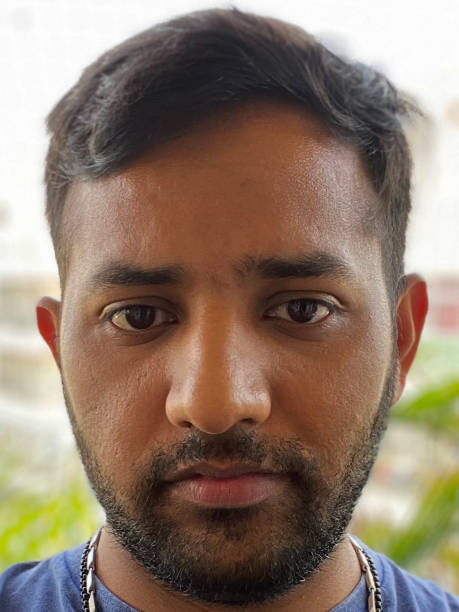 istock Image of Indian man outdoors on apartment balcony posing and looking somber whilst looking at camera 1336062154