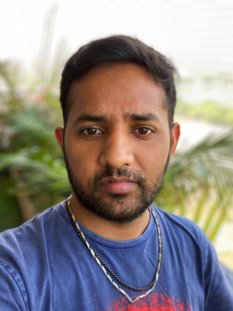 istock Image of Indian man outdoors on apartment balcony posing and looking somber whilst looking at camera 1336062163