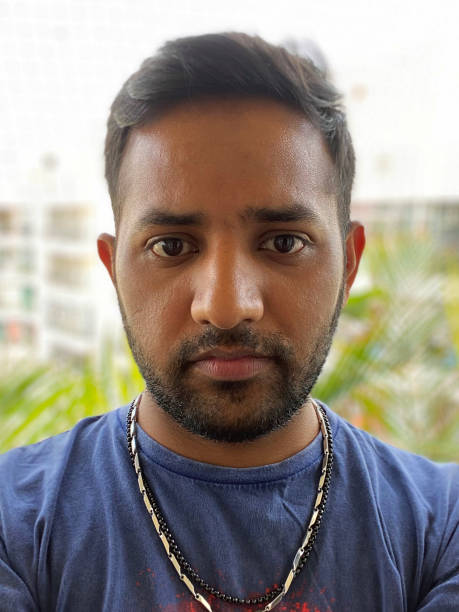 istock Image of Indian man outdoors on apartment balcony posing and looking somber whilst looking at camera 1336062165