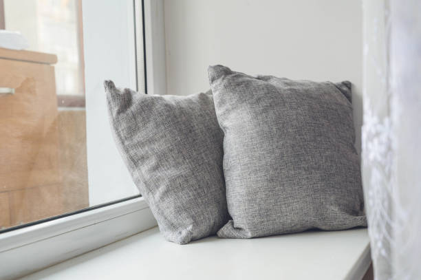 istock Soft cushions on white sill. Cozy pillows. 1336063134