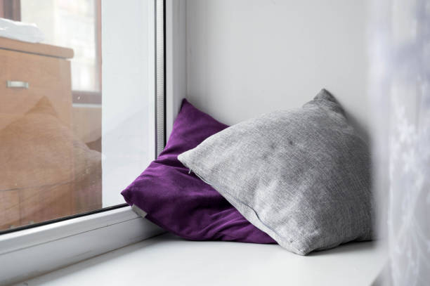 istock Soft cushions on white sill. Cozy pillows. 1336063146