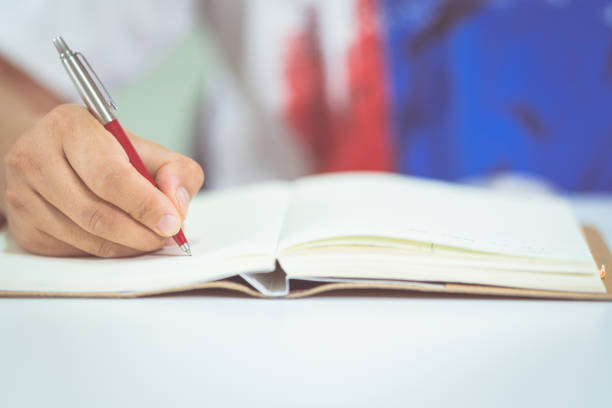 istock Closeup of a male student taking notes from learning lesson on a smartphone at home 1336068488