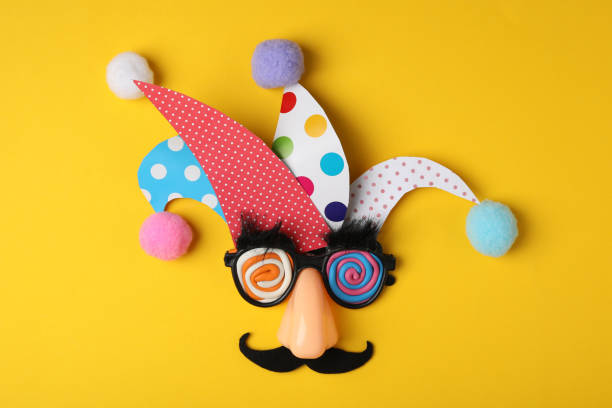 Funny face made of party items on yellow background, flat lay. April Fool's Day Funny face made of party items on yellow background, flat lay. April Fool's Day fool stock pictures, royalty-free photos & images