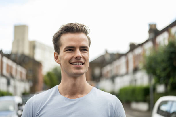 istock Cheerful young man standing outdoors in urban neighbourhood 1336070304