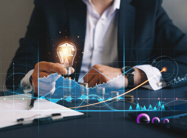 istock Financial technology with growth chart that helps to develop services and profits in global business. Businessman holding light bulb with banking icon. 1336071310