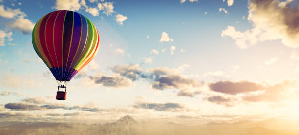 istock Hot air balloon flying above clouds at sunset 1336071774