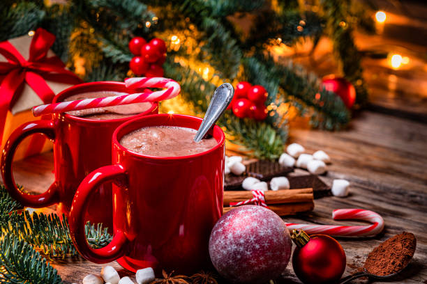 istock Hot chocolate mugs and candies on Christmas table 1336074398