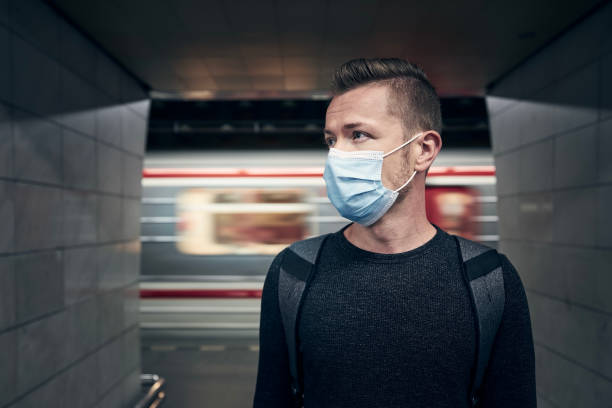 istock Man wearing face mask in underground station 1336075241