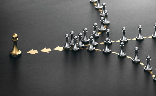Leader and followers over black background. Good leadership concept. 3D illustration of many pawns in a row over black background. Concept of lead. Following the leader. officer military rank photos stock pictures, royalty-free photos & images