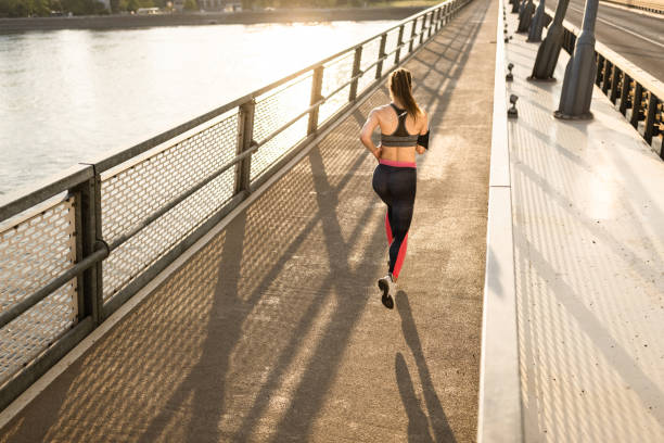 istock Fit woman running at the bridge 1336077038