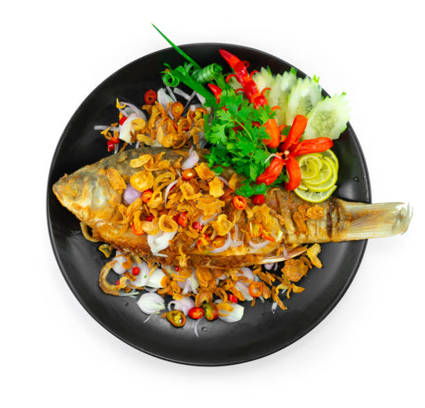 Fried Pickled Fish Sour Taste ontop Crispy Shallot,Chili and lime Thai Food stock photo