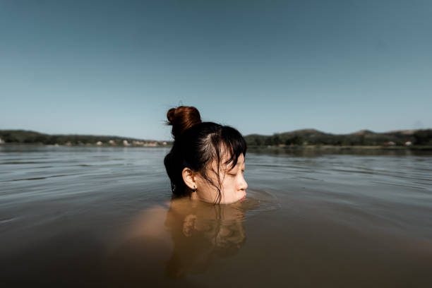 Photo of a young woman swimming in the lake