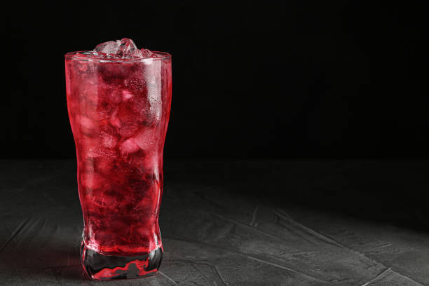 istock Tasty cocktail with ice cubes on grey table, closeup. Space for text 1336079615