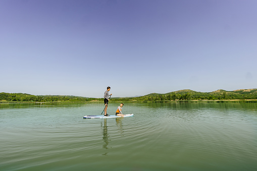 Photo of a couple paddling together on the lake