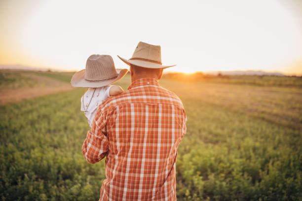 istock Senior farmer and grandson on a meadow 1336079793