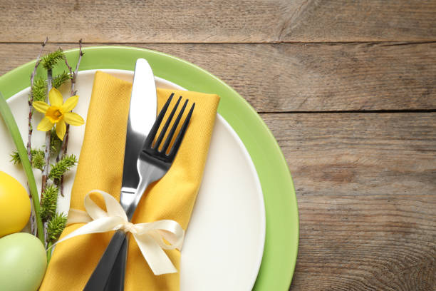 istock Festive Easter table setting with beautiful narcissus and painted eggs, top view. Space for text 1336079851