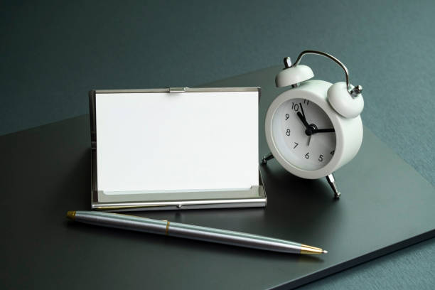 istock A modern desk with a business card and a desk clock. 1336080841