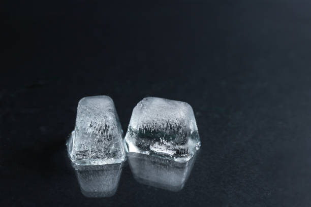 istock Ice cubes on wet black surface, closeup 1336080875