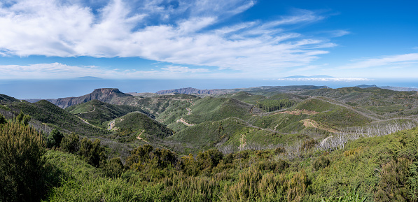 La Gomera - panoramic view from highest mountain Garajonay - landscape with mesa Fortaleza, on horizon the neighboring island El Hierro on the left and La Palma on the right