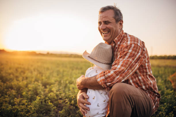 istock Farmer and grandson on a meadow 1336082214