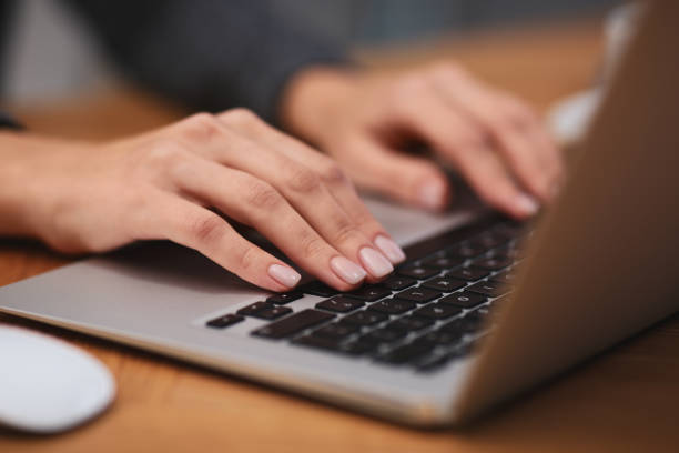 istock Woman working on modern laptop at table, closeup 1336086129
