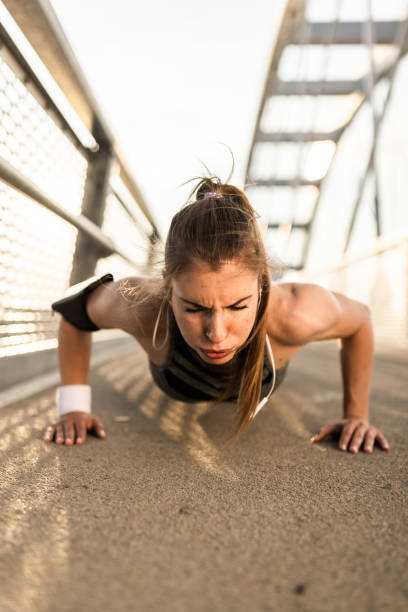 istock Young woman doing push ups on the bridge 1336086215
