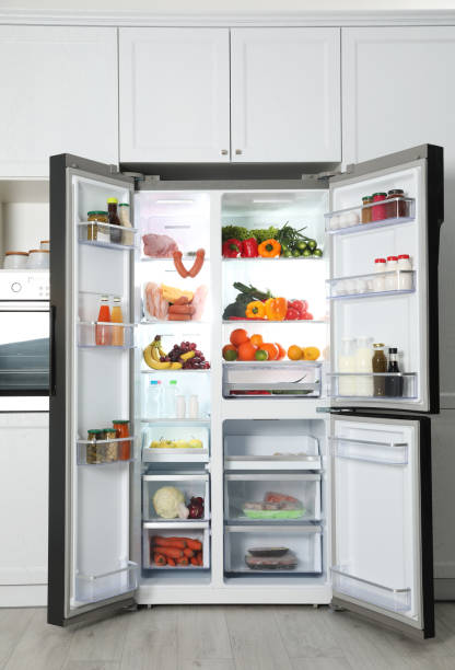 istock Open refrigerator filled with food in kitchen 1336086551