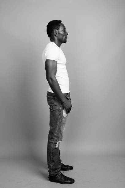 istock Side View Of Man Standing Against Gray Background 1336086608