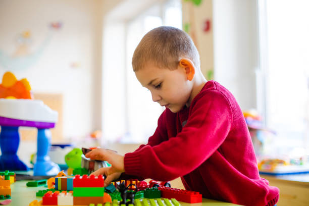 istock Side View Of Boy Playing With Toy At Home 1336086647