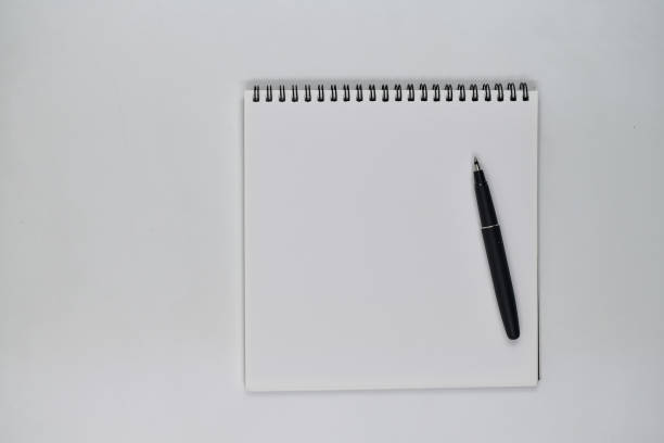 istock Flat lay photo, blank sheet of blank note and pen on white background 1336086716