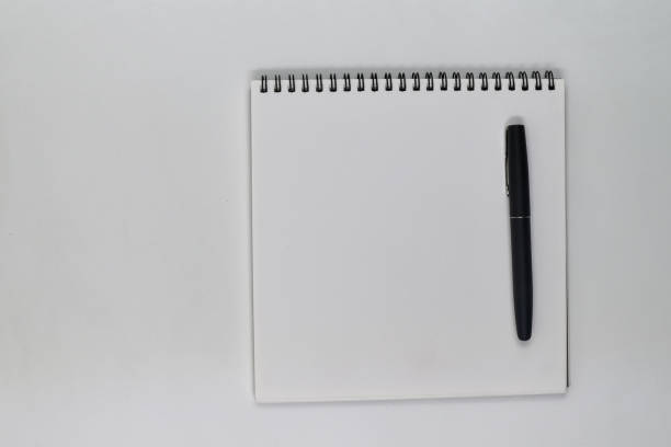 istock Flat lay photo, blank sheet of blank note and pen on white background 1336086719