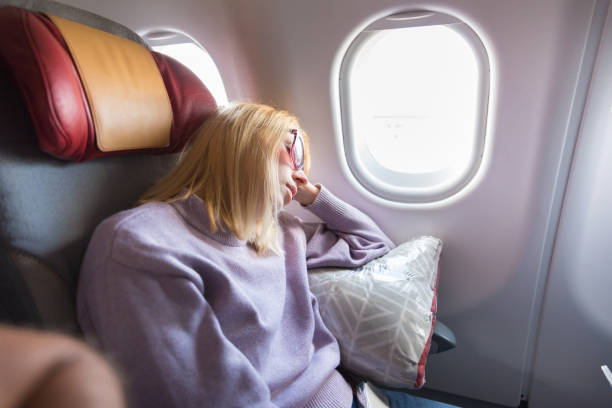 istock Woman Sitting In Airplane 1336088686