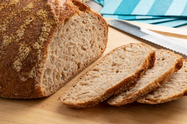 istock Sliced whole fresh baked German dinkel wheat bread on a cutting board 1336089428