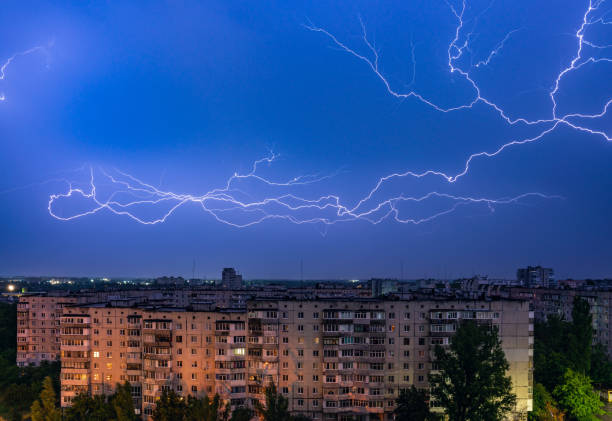 istock Thunderstorm with lightning above the night city 1336091959