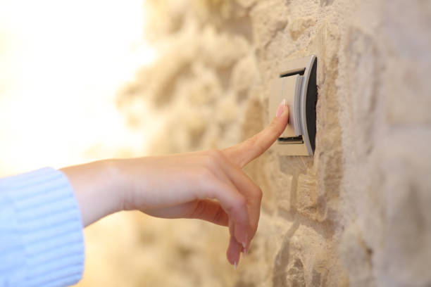 istock Woman hand turning on the light at home 1336092302