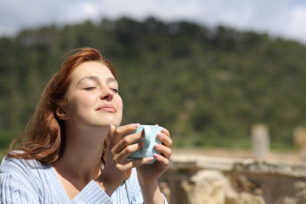 istock Woman enjoying outdoors holding a coffee cup 1336092876